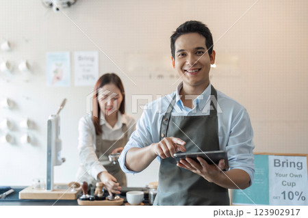 Sustainable Practices and Barista Skills. A barista cheerful while showcasing sustainable practices in the coffee-making process. 123902917