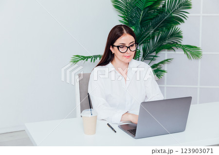 woman working at desk with laptop in online office training 123903071