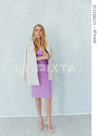 Beautiful blonde woman in summer dress in white room interior 123903132