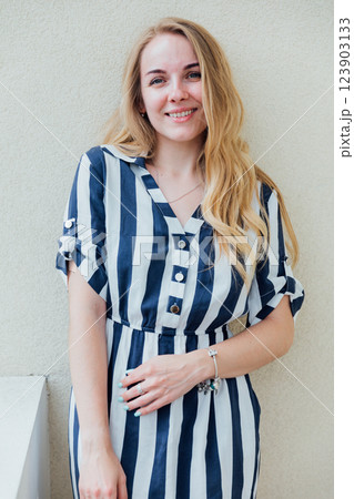 Beautiful fashionable woman in summer striped dress smiling 123903133