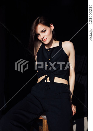 Fashionable woman sitting on a chair posing 123903230