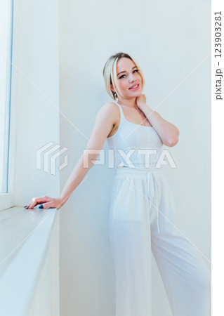 Beautiful slim gentle blonde woman in white clothes 123903281