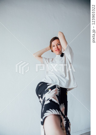 Beautiful woman of 40 years old in a fashionable suit on a white background Beautiful woman of 40 years old in a fashionable suit on a white background 123903322