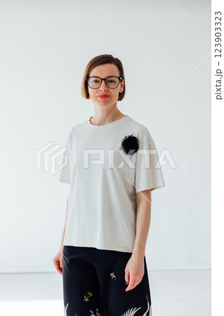 Beautiful woman of 40 years old in a fashionable suit on a white background Beautiful woman of 40 years old in a fashionable suit on a white background 123903323