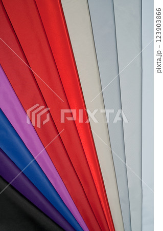 Vibrant fabric strips in red, purple, blue, and gray. 123903866