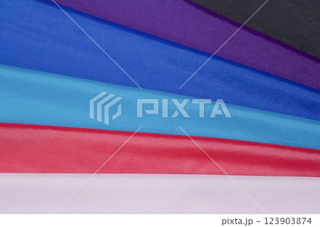 Multi-colored fabrics with a smooth texture and bright shades. 123903874