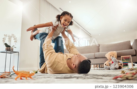 Happy family, father and girl playing in a house with freedom, bonding and enjoying quality time together. Happiness, smile and child flying in dads arms on the floor on a weekend at home in Portugal Happy family, father and girl playing in a house with freedom, bonding and enjoying quality time together. Happiness, smile and child flying in dads arms on the floor on a weekend at home in Portugal 123904306