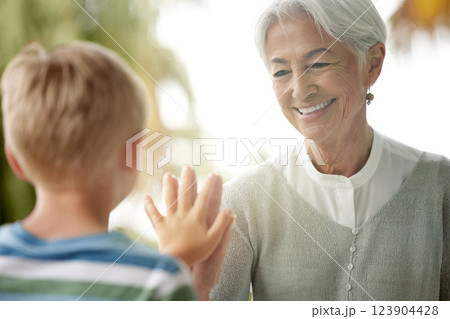 Covid, grandmother and child touching window for safety, social distancing and risk in covid 19 pandemic. Family, love and boy connect hand with grandma on glass in isolation, quarantine and lockdown 123904428