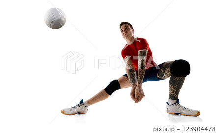 Front view dynamic image of man, volleyball player in motion, hitting ball, showing skills and focus against white studio background 123904478