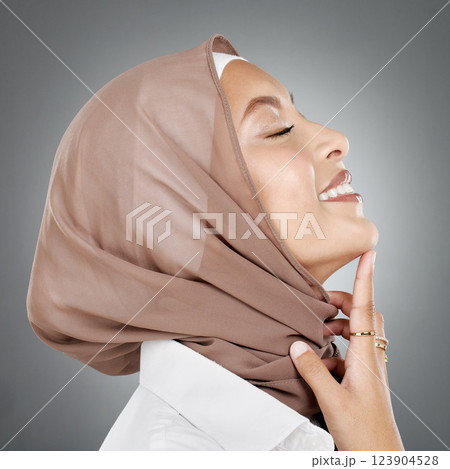 Face, beauty or skincare with a woman muslim wearing a hijab in studio on a gray background for natural wellness. Cosmetics, happy and skin with an Islam female in a headscarf to promote health 123904528