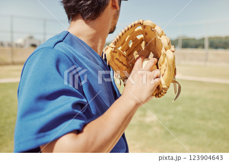 Baseball, sports and man pitching during a game, training and professional event on a field. Back of athlete ready to throw a ball with a glove during an outdoor competition, fitness or cardio 123904643