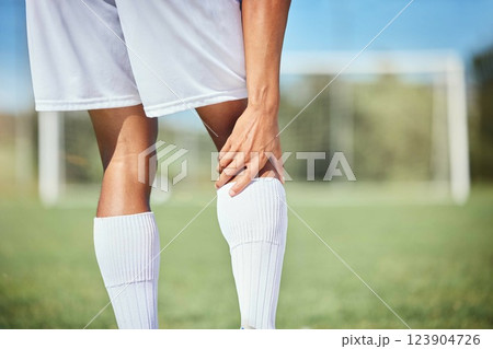 Sports, soccer player and man with knee injury, torn muscle or strain after game, competition or fitness practice. Exercise, grass pitch workout or football training accident for athlete legs in pain 123904726