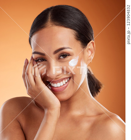 Skincare, beauty cream and woman with cream on face product against a orange mockup studio background. Happy and smile model with cosmetics for skin, body wellness and cosmetology or dermatology 123904832