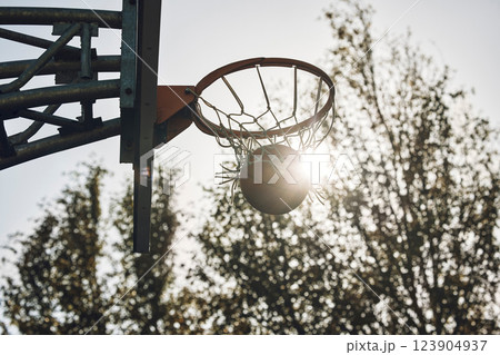 Basketball court net, silhouette and sports playing game, competition and action match outdoor. Empty background winning, goal target aim and shooting hoops skills training, hobby and fun performance 123904937