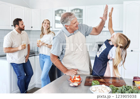 High five, happy family and cooking together success in kitchen bonding activity. Parents smile, senior man teach kid to make healthy lunch and good job child development through learning at home 123905038