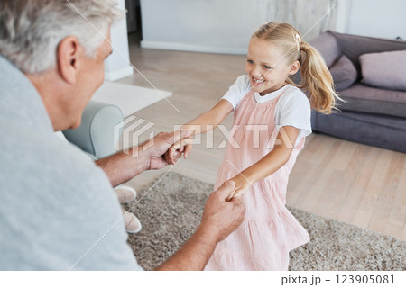 Family love, grandfather and child, playing at family home and bonding together in living room. Senior man, young girl have fun and playful, swing and hand holding, happy in retirement and holiday. 123905081