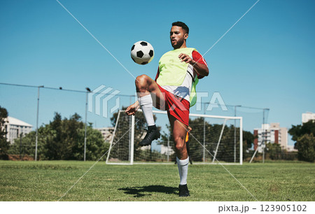 Soccer, football game and black man player on a sports field with a match ball. Fitness, training exercise and health cardio of an athlete workout exercising with energy and motivation in nature 123905102