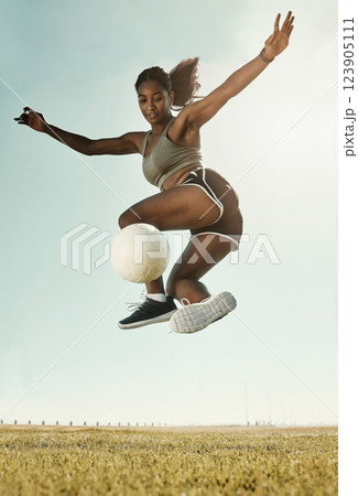 Soccer, sport and black woman training on a field for competition, cardio and fitness during summer. Young, focus and African athlete doing a trick during football exercise on sport ground or park Soccer, sport and black woman training on a field for competition, cardio and fitness during summer. Young, focus and African athlete doing a trick during football exercise on sport ground or park 123905111