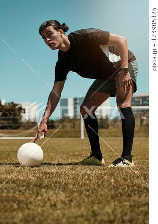 Man, placing and soccer ball with hand on field for kick, penalty or goal in game, training or match. Sport, football and grass in summer for exercise, fitness and workout in sports for wellness 123905125