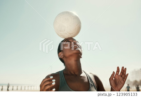 Head balance, sports and soccer ball with woman athlete in the sun and nature. Fitness, balancing concentration and football exercise of a black person busy with workout, training and healthy cardio Head balance, sports and soccer ball with woman athlete in the sun and nature. Fitness, balancing concentration and football exercise of a black person busy with workout, training and healthy cardio 123905133