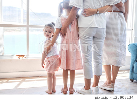 Women, children and generations, rear view at window, back legs and toddler girl looking with smile. Love, support and happy family together in holiday home in Sydney, Australia on first vacation day 123905134