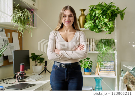 Portrait of young confident smiling woman in home interior Portrait of young confident smiling woman in home interior 123905211