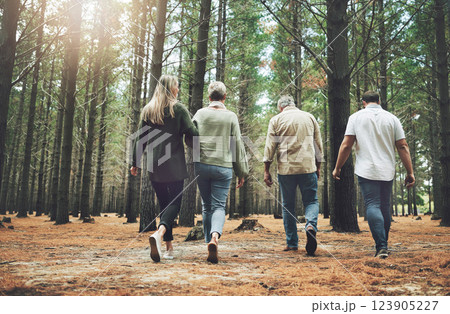 Family, friends and forest adventure with parents and adult children walking in nature for outdoor hiking, fun and trees on wellness vacation. Running, couple and travel men and women in woods 123905227