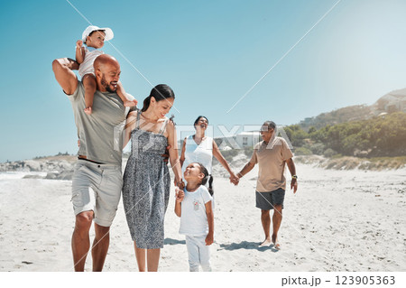 Travel, summer and big family holding hands at beach and walking on vacation, wellness and support together. Smile, love and relax on sea side holiday with happy parents, children and grandparents 123905363