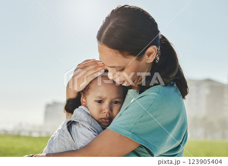 Woman, child and sad with comfort, love and care in hug, embrace and holding outdoor at park. Mom, kid and together for support, attention and help for depression, mental health and problem in sun 123905404