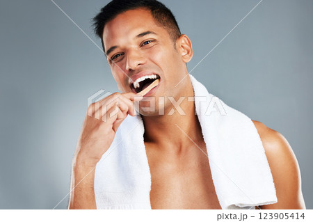 Man, toothbrush and teeth for dental hygiene in clean, fresh and wash for healthcare against a grey studio background. Portrait of a toothy male brushing mouth for oral and gum care treatment 123905414