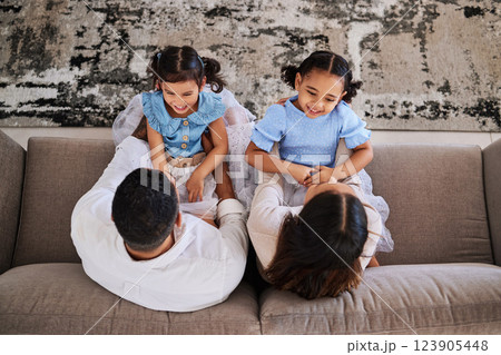 Children, family and laugh with a girl, sister and parents having fun on a sofa at home together from above. Kids, love and humor with a mother, father and daughter siblings bonding in a house Children, family and laugh with a girl, sister and parents having fun on a sofa at home together from above. Kids, love and humor with a mother, father and daughter siblings bonding in a house 123905448