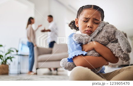 Parents fight, sad girl and teddy hug of a child crying from divorce in a home living room. Depressed kid, problem and youth anxiety of children depression from mama and dad family fighting 123905470