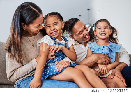 Love, family and happy kids relax and play with parents on sofa, laughing, cheerful and having fun. Happy family, girls and loving mother and father enjoy quality time with smiling children at home 123905555