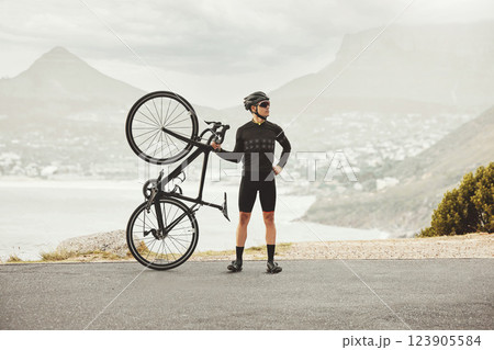 Fitness, sports and cycling man with his bike on a mountain road for health, wellness and morning cardio exercise. Athlete male with outdoor for energy, workout and marathon training with a bicycle 123905584