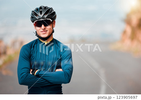 Sports man, vision and cycling success by cyclist on mountain route road with arms folded, power and health. Fitness, sport and performance goal by guy athlete looking proud, ready and strong mindset 123905697