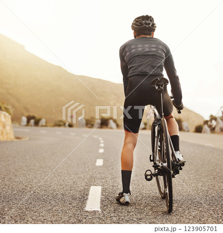 Cyclist, countryside road or fitness bike for sunrise workout, training and exercise for health goals, wellness or heart cardio. Man, sports person or bicycle athlete on Australian street with helmet Cyclist, countryside road or fitness bike for sunrise workout, training and exercise for health goals, wellness or heart cardio. Man, sports person or bicycle athlete on Australian street with helmet 123905701