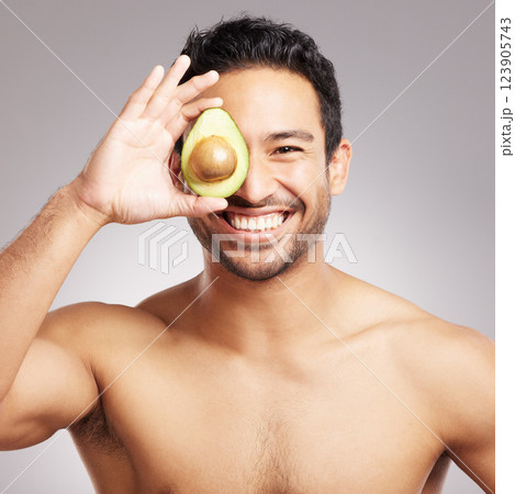 Avocado, beauty and portrait of man in studio for natural cosmetics or dermatology routine. Aesthetic, detox and skincare with shirtless model on gray background for cosmetology or satisfaction 123905743