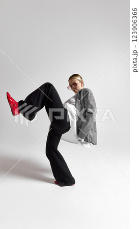 Full body photo of stylish young female professional, leaping, do big step to career growth against white background. 123906366
