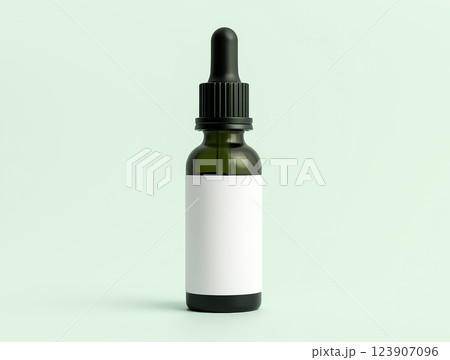 Green glass dropper bottle on a light background for cosmetic or medicinal use Green glass dropper bottle on a light background for cosmetic or medicinal use 123907096