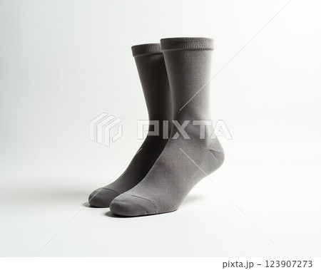 Gray cotton socks positioned evenly on a neutral background highlighting texture and simplicity in minimalist design Gray cotton socks positioned evenly on a neutral background highlighting texture and simplicity in minimalist design 123907273