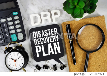 DRP - Disaster Recovery Plan acronym with calculator, alarm clock and magnifying glass, Business concept background 123907971