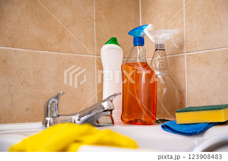 Spray detergents, cleaning bathroom tube and water tap, yellow gloves and fibber cloth Spray detergents, cleaning bathroom tube and water tap, yellow gloves and fibber cloth 123908483