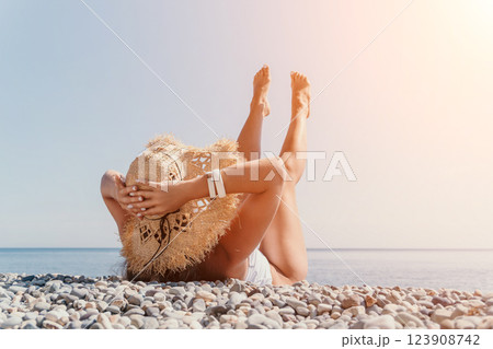 Beach Woman Sunbathing Relaxation - Relaxing Woman in Beach Hat - Summer Vacation Sunbathing on the Beach Beach Woman Sunbathing Relaxation - Relaxing Woman in Beach Hat - Summer Vacation Sunbathing on the Beach 123908742