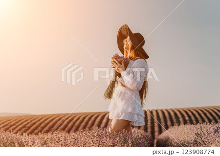 A Woman in a White Dress and Hat in a Lavender Field 123908774