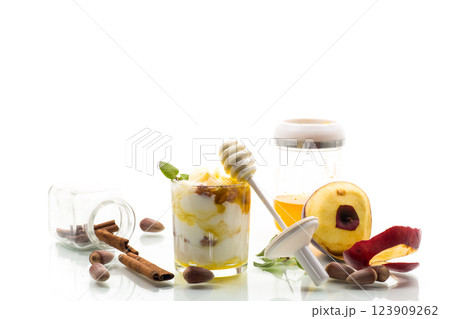 sweet homemade yogurt in a glass with apples, nuts and honey 123909262