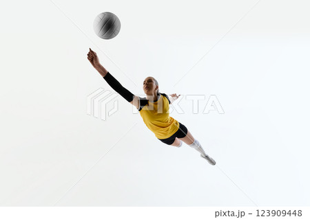 Bottom view image of young concentrated woman, volleyball athlete in motion during training session, competing isolated on white background Bottom view image of young concentrated woman, volleyball athlete in motion during training session, competing isolated on white background 123909448