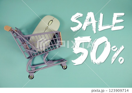 Sale 50% Special Discount shopping online with trolley shopping cart and optical mouse on blue background Sale 50% Special Discount shopping online with trolley shopping cart and optical mouse on blue background 123909714