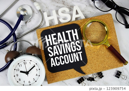 HSA - Health Savings Account acronym with alarm stethoscope, alarm clock and magnifying glass, medical and healthcare concept background 123909754