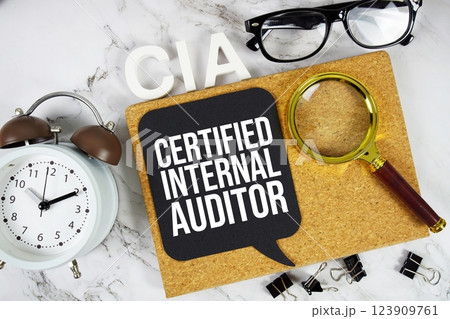 CIA - Certified Internal Auditor acronym with alarm clock and magnifying glass, Business concept background 123909761