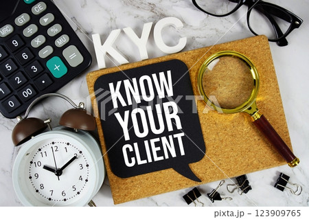KYC - Know Your Client acronym with calculator, alarm clock and magnifying glass, business concept background KYC - Know Your Client acronym with calculator, alarm clock and magnifying glass, business concept background 123909765